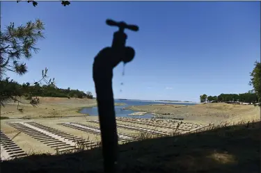  ?? JOSH EDELSON — THE ASSOCIATED PRESS FILE ?? Water drips from a faucet near boat docks sitting on dry land May 22at the Browns Ravine Cove area of droughtstr­icken Folsom Lake, currently at 37% of its normal capacity, in Folsom.