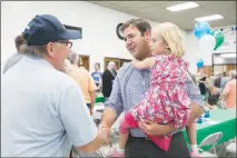  ?? MADDIE MCGARVEY / THE NEW YORK TIMES ?? Danny O’connor, the Democratic candidate in Ohio’s 12th District special election, greets a voter during an event July 24 in Newark, Ohio. O’connor appealed to voters who were tired of big money’s inf luence in politics.