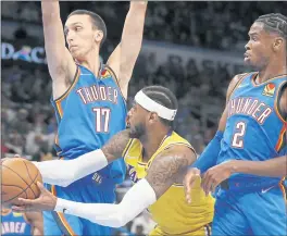  ?? GARETT FISBECK — THE ASSOCIATED PRESS ?? The Lakers’ Carmelo Anthony looks to pass, surrounded by the Thunder’s Aleksej Pokusevski, left, and Shai Gilgeous-Alexander. The Lakers were without LeBron James and lost.