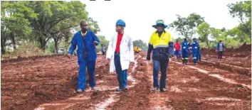  ??  ?? Minister Joel Biggie Matiza (centre) with road engineers working on the Beatrice section of the Beitbridge-Harare-Chirundu Highway rehabilita­tion