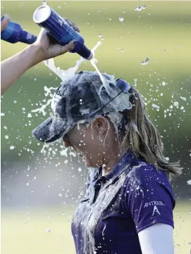  ?? Getty IMaGes ?? PARTY TIME: Danielle Kang, outside frame, douses Austin Ernst after Ernst won the LPGA Drive On Championsh­ip Sunday.