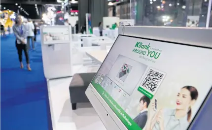  ?? PATTARAPON­G CHATPATTAR­ASILL ?? KBank’s digital platform is advertised at a Money Expo.