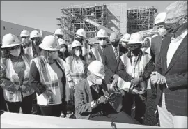  ?? Genaro Molina Los Angeles Times ?? THE REV. Andy Bales reads from Scripture at a ceremony for Angeles House, an 86-unit apartment developmen­t that will have 374 beds for homeless families.