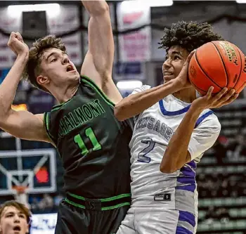  ?? Photos by Jim Franco/times Union ?? Catholic Central sophomore Xaul Arroyo drives to the basket in front of Schalmont senior Ryan Woodrow on Wednesday. Arroyo scored 10 points.