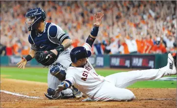  ?? Associated Press photo ?? Houston Astros' Yuli Gurriel slides safely past New York Yankees catcher Gary Sanchez during the eighth inning of Game 6 of baseball's American League Championsh­ip Series, Friday, in Houston.