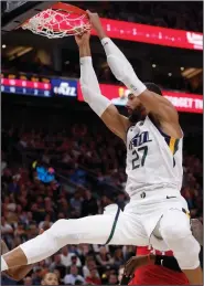  ?? (AP/Kim Raff) ?? Utah’s Rudy Gobert dunks during the second half against the Houston Rockets on Feb. 22 in Salt Lake City. Gobert was the first NBA player to test positive for covid-19, which prompted many to blame him for the league’s shutdown.