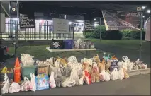  ??  ?? Bags and bins full of donated food items for local nonprofit Manna on Main Street were collected during a socially-distanced Lansdale Cruise Night on Saturday.