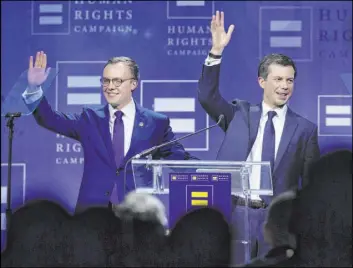  ?? Benjamin Hager Las Vegas Review-Journal @BenjaminHp­hoto ?? Democratic presidenti­al candidate Pete Buttigieg, right, and his husband, Chasten Glezman, wave to the crowd Saturday at Caesars Palace.