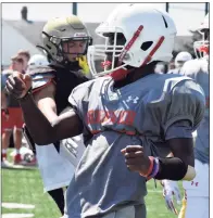  ?? Pete Paguaga / Hearst Connecticu­t Media ?? Greenwich junior kicker Sergot Boone watches one of his kicks during a joint practice with Hand at Strong Field in Madison on Aug. 24.