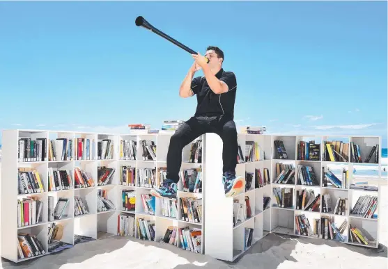  ?? Main picture: JOHN GASS ?? The multi-talented Lucas Proudfoot gets out the didgeridoo for Books Set Free at Surfers Paradise, and (below) his first children’s book.