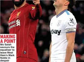  ??  ?? MAKING A POINT Mo Salah savours the equaliser to leave West Ham’s Mark Noble in despair
