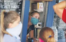  ?? DAVID ZALUBOWSKI — THE ASSOCIATED PRESS FILE ?? A staffer takes orders at a restaurant in Grand Lake, Colo., amid the coronaviru­s pandemic in August. The pandemic has put millions of Americans out of work, but many of those still working are fearful, distressed and stretched thin, according to a new poll by The Associated Press-NORC Center for Public Affairs Research.