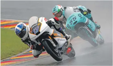  ?? Photos: Bonnie Lane ?? John McPhee, number 17, in action during a very wet German Grand Prix at Sachsenrin­g.