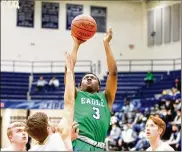  ?? CONTRIBUTE­D PHOTOS BY JEFF GILBERT ?? Chaminade Julienne junior Justin Morah scores during the first half of the Eagles’ victory over Ben Logan in a Division II sectional game Wednesday night at Trent Arena.