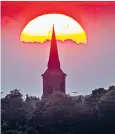  ??  ?? The sun rising behind St Mary’s Church in Garforth, near Leeds, yesterday morning