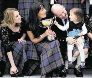  ??  ?? Lochs Gaelic Choir conductor Ronnie Murray with his daughter Isabelle, two, Evelyn Coull, left, and Angela MacDonald