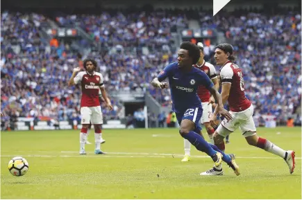  ??  ?? Fall guy...Chelsea’s Willian (in blue) is clipped by Hector Bellerin of Arsenal