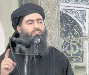  ?? AP ?? This image from a video posted on a militant website on July 5, 2014, purports to show the leader of the Islamic State group, Abu Bakr al-Baghdadi, delivering a sermon at a mosque in Iraq during his first public appearance.
