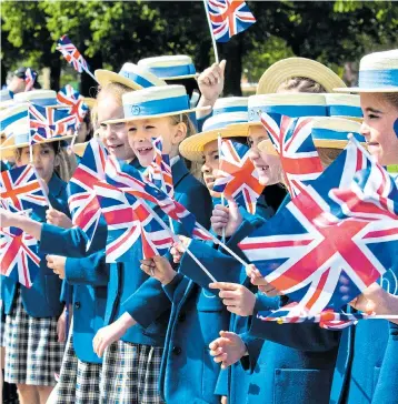  ??  ?? Children from Upton House prep school in Windsor getting ready for the big day yesterday