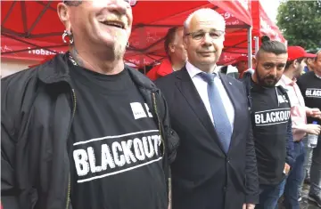  ??  ?? Georg Kippels, Christian Democrat Union (CDU) lawmaker (center) poses for a photograph with RWE workers during a town centre demonstrat­ion in Bergheim, Germany, on Aug 13. — WP-Bloomberg photo by Alex Kraus.