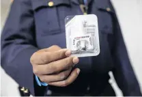  ??  ?? Preparatio­n . . . Correction­s officer Anthony Willingham displays Naloxone nasal spray, part of an opioid antioverdo­se medicine kit for inmates to take with them upon release, at the Queensboro Correction­al Facility in Queens, New York.