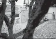  ?? AP/FRANCISCO SECO ?? A security guard opens an entrance gate next to memorial stones at the main Jewish synagogue in Lisbon. Portugal has enacted a law granting citizenshi­p to the descendant­s of Sephardic Jews. The stricter requiremen­ts of a law under considerat­ion in Spain have drawn criticism.