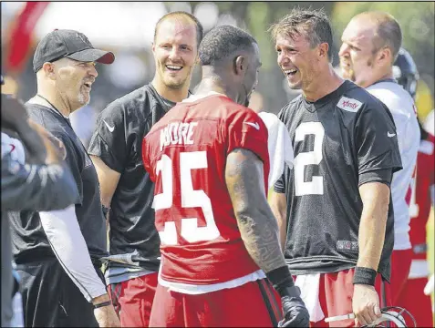  ?? PHOTOS BY CURTIS COMPTON / CCOMPTON@AJC.COM ?? In his first camp with the Falcons, head coach Dan Quinn (from left) shares a laugh with quarterbac­k T.J. Yates, safety William Moore and quarterbac­k Matt Ryan after Moore broke up a play.