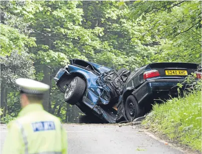  ??  ?? The wreckage of the car following the crash in which Brian Phimister was killed.