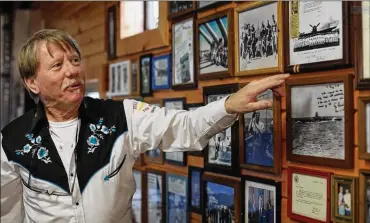  ?? AMY E. VOIGT / THE (TOLDEO) BLADE ?? Michael “The Cowboy” Stevenson shows a letter he received from George H.W. Bush that now hangs on a wall in his home. “He was a people’s president,” Stevenson said. “He had heart.”