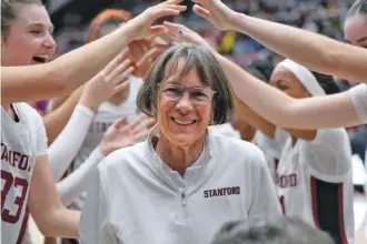  ?? AP PHOTO/TONY AVELAR ?? Tara VanDerveer smiles as the Stanford women’s basketball team celebrates her 1,202nd career victory Friday night. The host Cardinal beat Oregon 88-63 as VanDerveer tied the retired Mike Krzyzewski for the all-time wins record among college basketball coaches.