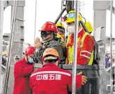  ?? PHOTO: REUTERS ?? Safe: Rescue workers help a miner as he is brought to the surface at the Hushan gold mine yesterday.