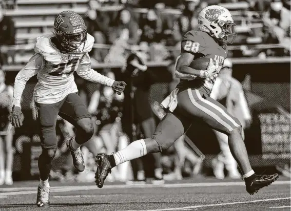  ?? Photos by Elizabeth Conley / Staff photograph­er ?? Senior running back Jalen Davis gets past Buda Hays’ Marcus Taylor on his way to 111 yards and two touchdowns in Katy’s win Saturday at Baylor’s McLane Stadium.