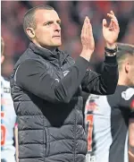  ??  ?? St Mirren boss Oran Kearney acknowledg­es the travelling fans at the end of the first leg at Tannadice.