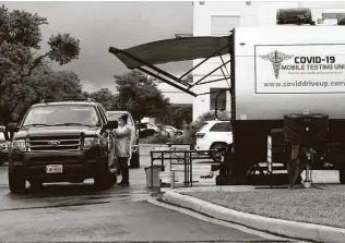  ??  ?? Jenny Balch administer­s a test for a customer at a drive-up testing unit parked by Livingston Med Lab in the Stone Oak area.