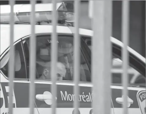  ?? VINCENZO D’ALTO/ GAZETTE FILES ?? An alleged street gang member waits in a police cruiser. Montreal’s 46-member anti-gang squad may be forced to disband if no funding is found by April.