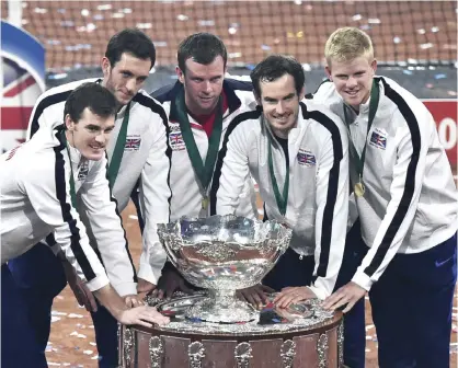  ??  ?? GHENT: (From L) Britain’s Jamie Murray, Britain’s James Ward, Britain’s captain Leon Smith, Britain’s Andy Murray and Britain’s Kyle Edmund pose with the trophy after winning the Davis Cup tennis final against Belgium at Flanders Expo in Ghent...