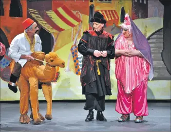  ?? 01_B51panto03 ?? Genghis and the Queen look on in disgust at a travelling camel rider.