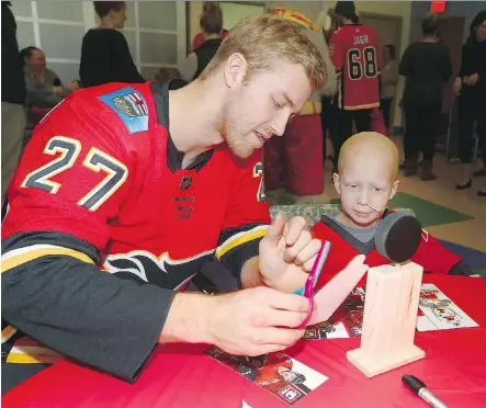  ?? JIM WELLS ?? Flames defenceman Dougie Hamilton fits the Canadian profile of being a “character” guy as he mingles with the youngsters at the Alberta Children’s Hospital. Hamilton is one of 17 Canadians on the Flames’ roster.