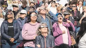  ?? RYAN REMIORZ THE CANADIAN PRESS ?? People watch the total solar eclipse at Parc Jean Drapeau in Montreal. A February report from Airbnb said Montreal and the Niagara Region were among the most popular cities on its platform along the path of totality.