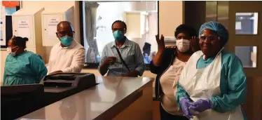  ?? African News Agency (ANA) ?? NURSES and doctors at the Khayelitsh­a District Hospital. Nehawu is accusing the health department across the nine provinces of forcing healthcare employees to work without personal protective equipment. |