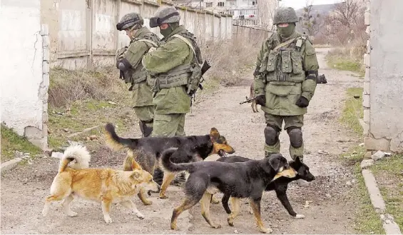  ?? REUTERS ?? Crimea.
Efectivos militares presumible­mente rusos pero sin insignias patrullan en cercanías de una base militar ubicada en la Península de Crimea./