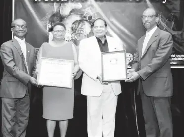  ??  ?? (From left) Dr. William Adu-Krow, PAHO/WHO Representa­tive Guyana hands over the certificat­e of recognitio­n to Minister of Public Health, Volda Lawrence and Prime Minister Moses Nagamootoo receives the World No Tobacco Day award from Director of...