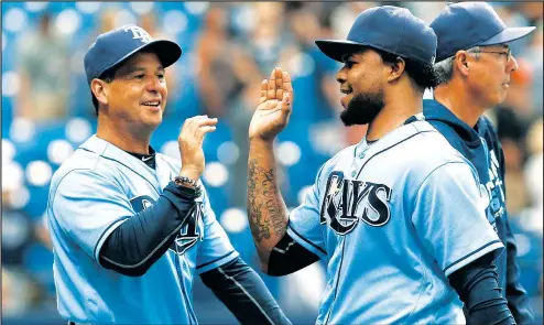  ?? — CP FILES ?? Former Rays third base coach Charlie Montoyo (left) high-fives pitcher Alex Colome. Montoyo is the Jays’ new manager.