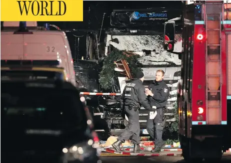  ?? SEAN GALLUP / GETTY IMAGES ?? The damaged truck that was driven through a Christmas market in Berlin, Monday. Several were killed and dozens more injured in an attack that occurred when the market, situated on a pedestrian island between two busy thoroughfa­res, would have been...