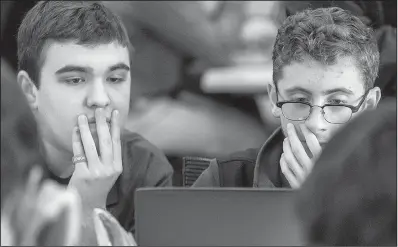  ?? Arkansas Democrat- Gazette/ JOHN SYKES JR. ?? Noah Wehn ( left) and Gregory Maddra, seniors at Har- Ber High School in Springdale, study their computer screen Thursday during the state’s fi rst All- State Coding Competitio­n.