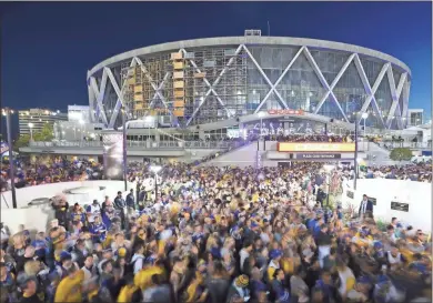  ?? Ap-josh Edelson, File ?? In this 2018 photo, Golden State Warriors fans celebrate outside Oracle Arena in Oakland, Calif. With the distinct possibilit­y of pro sports resuming in empty venues, a recent poll suggests a majority of U.S. fans wouldn’t feel safe attending games anyway without a coronaviru­s vaccine.