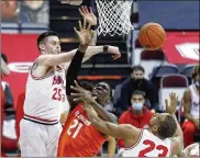  ?? PAUL VERNON / AP ?? Ohio State forward Kyle Young (left) knocks the ball away from Illinois center Kofi Cockburn as forward Zed Key defends during the first half of a Big Ten clash Saturday in Columbus. The Buckeyes lost 73-68.