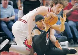  ?? Luis Cinco Los Angeles Times ?? CLIPPERS forward Tobias Harris, battling for the ball against Bulls center Robin Lopez at Staples Center, was acquired from Detroit prior to the trade deadline.