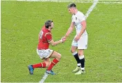  ??  ?? Battle scarred: England fly-half Owen Farrell helps opposite number Dan Biggar to his feet at the end of the match; (below) England head coach Eddie Jones