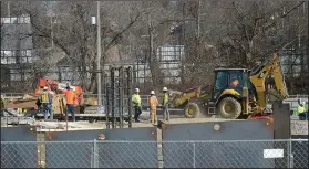  ?? NWA Democrat-Gazette/ANDY SHUPE ?? Nabholz Constructi­on employees work Friday at the site of a planned dormitory on the south end of Stadium Drive near Bud Walton Arena on the University of Arkansas campus in Fayettevil­le.